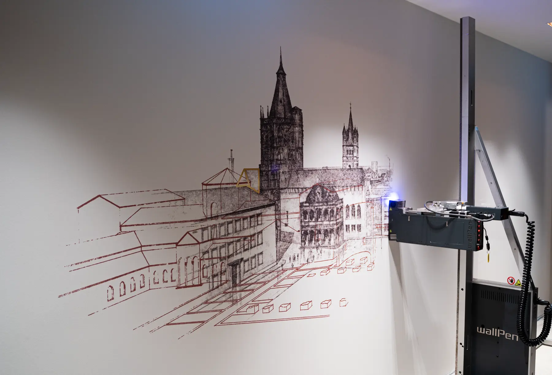 Wanddrucker trägt eine Stadtsilhouette von Köln auf eine Wand auf